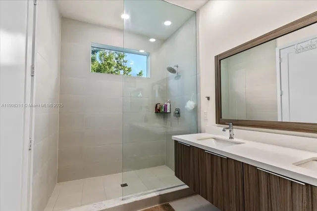 a bathroom with a double vanity sink and a mirror