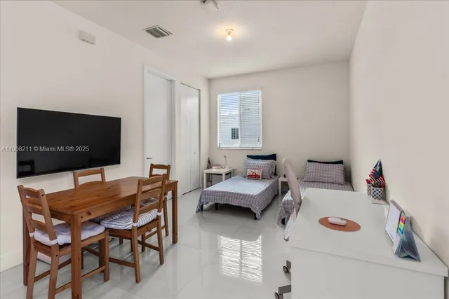 a dining room with furniture and a flat screen tv
