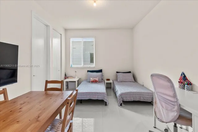 a bedroom with furniture and a flat screen tv