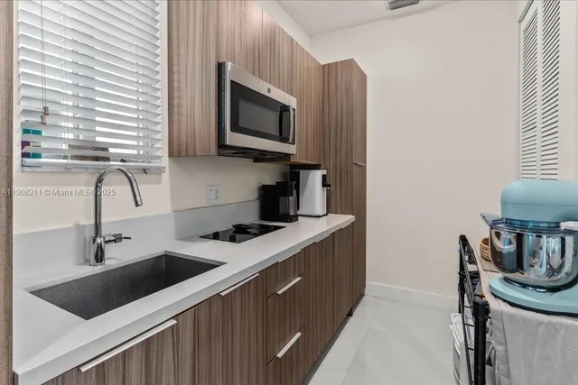 a kitchen with stainless steel appliances a sink a stove and a microwave