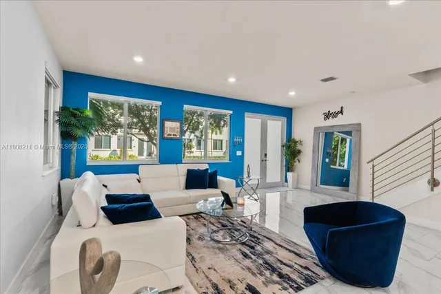 a living room with furniture and a large window