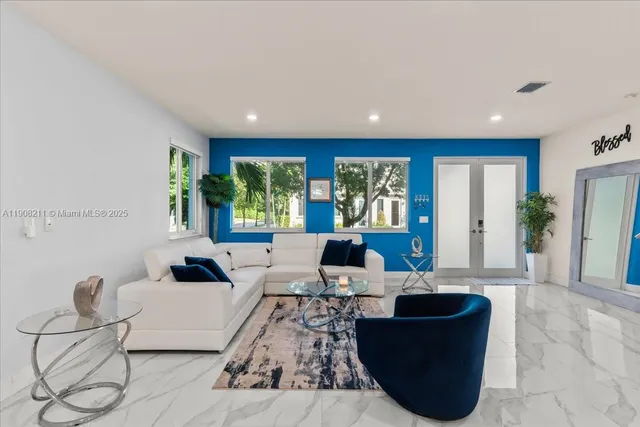 a living room with furniture and a large window