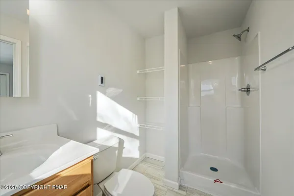 a bathroom with a sink toilet and shower