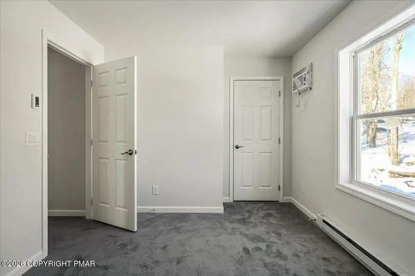 a view of an empty room with a window