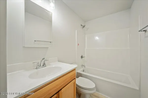 a bathroom with a sink toilet vanity and shower