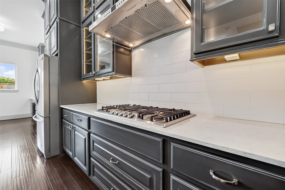 10514 Concha Lane Houston, TX 77096 - Photo 13 of 50 5-Burner Gas Cooktop. Close up of sleek countertops and subway style tile backsplash.