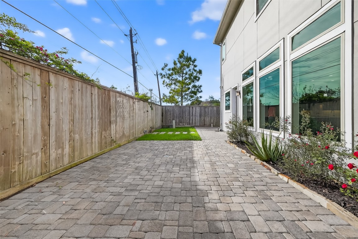 10514 Concha Lane Houston, TX 77096 - Photo 32 of 50 View of brick paver back patio. Wood privacy fence. Sprinkler system.