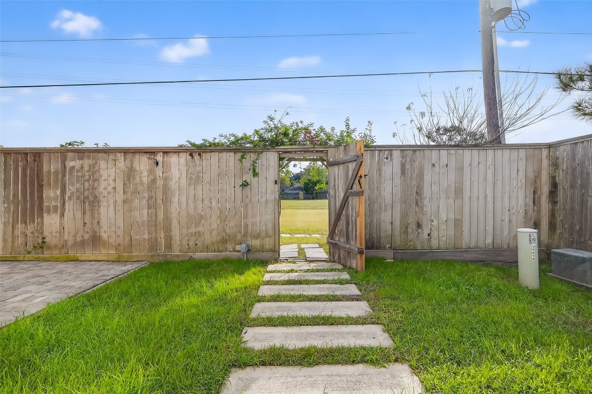 10514 Concha Lane Houston, TX 77096 - Photo 35 of 50 Path leading to back gate which accesses the large open easement greenspace behind the property.