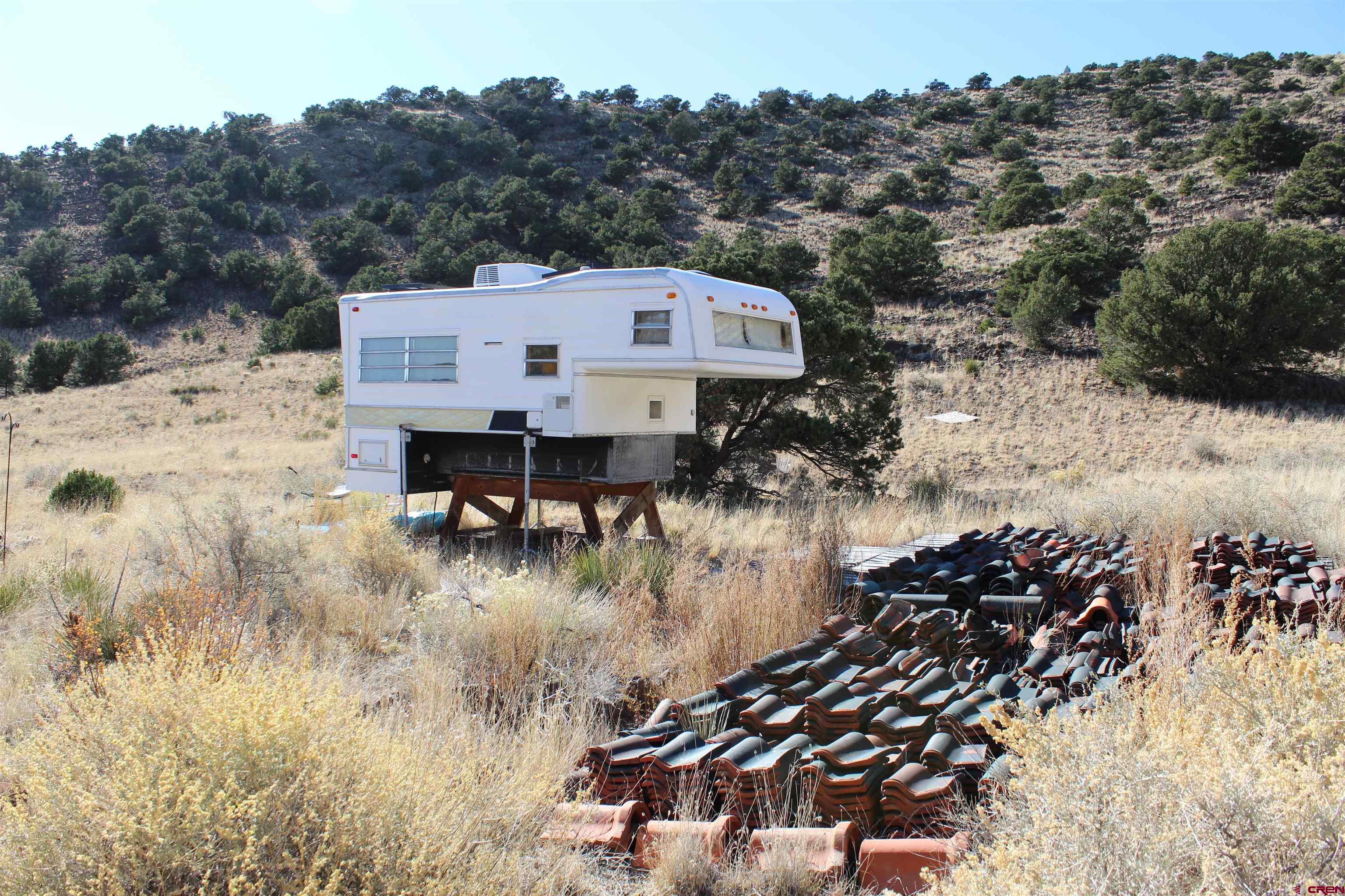 7 Ghost Mine Ranch Del Norte, CO 81132 - Photo 20 of 35 a view of a house with a yard from a lake view