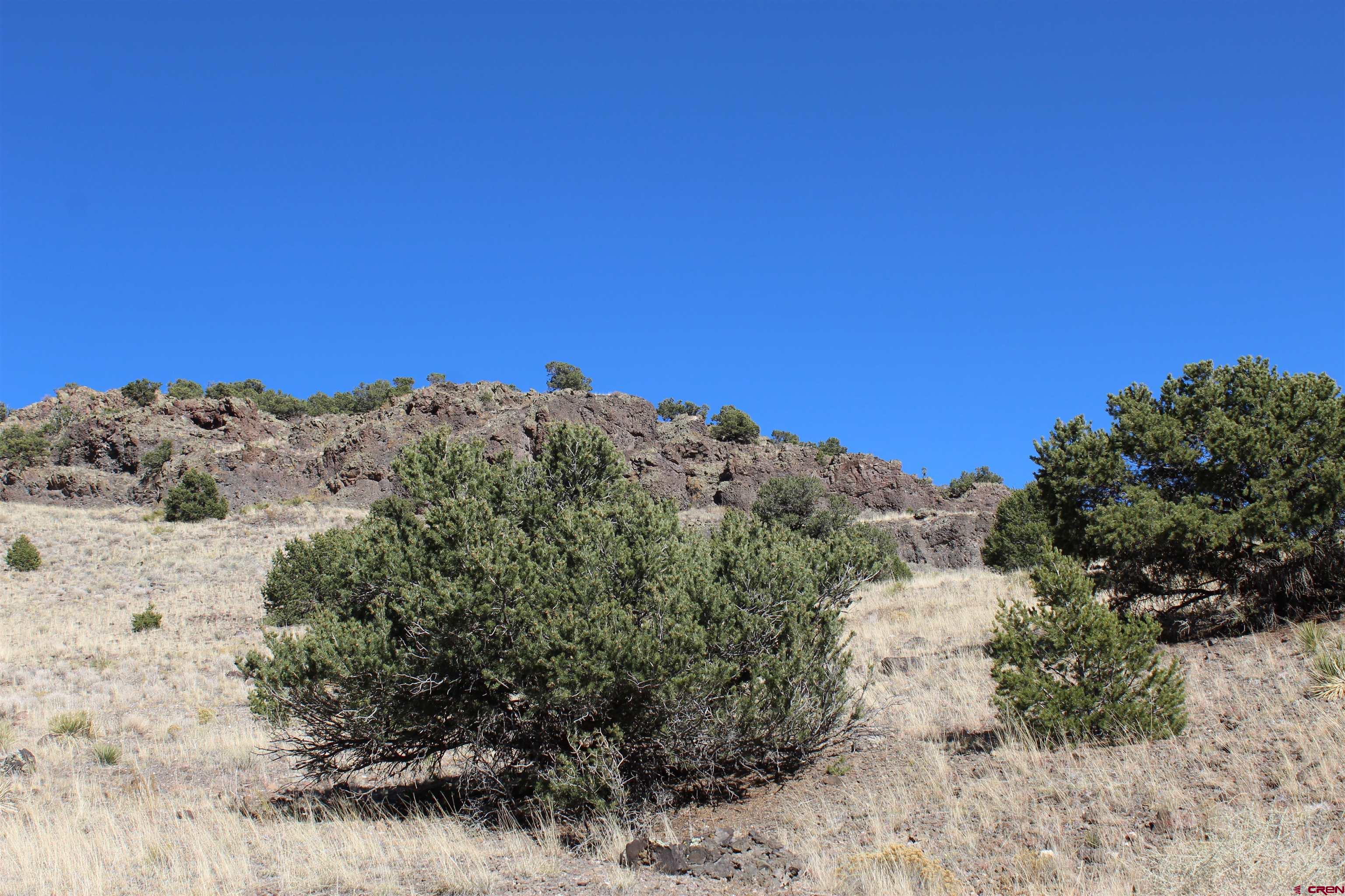 7 Ghost Mine Ranch Del Norte, CO 81132 - Photo 22 of 35 a view of a beach with a mountain in the background