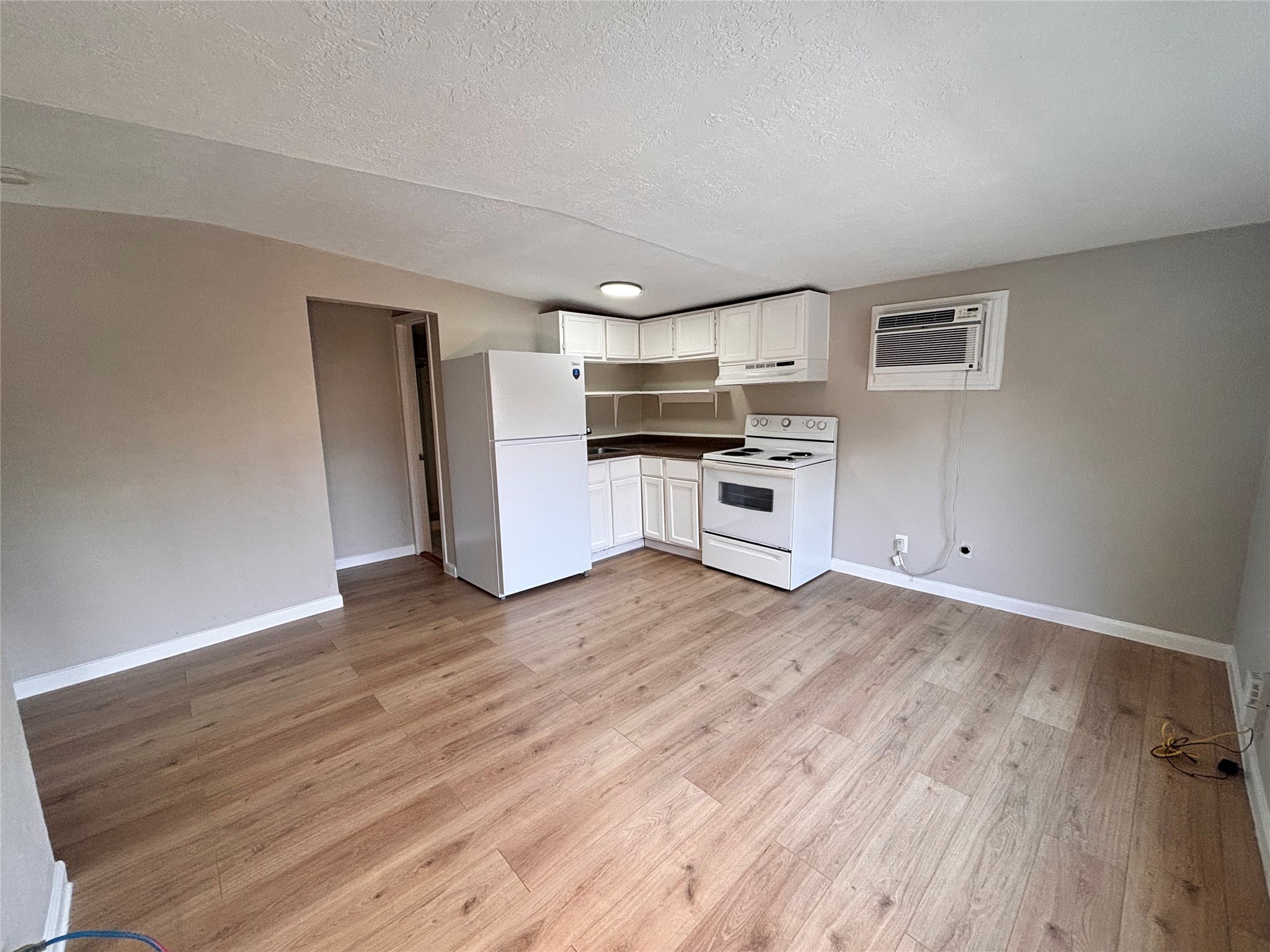 216 Redan Street, Unit 4 Houston, TX 77009 - Photo 3 of 8 a kitchen with a refrigerator and a stove top oven