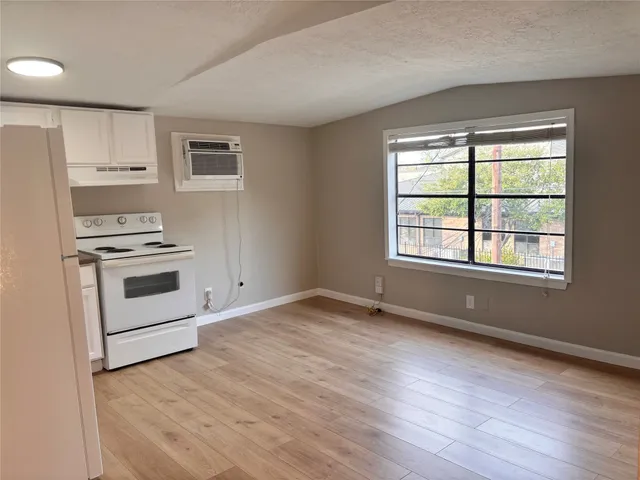 a view of wooden floor and windows in a room