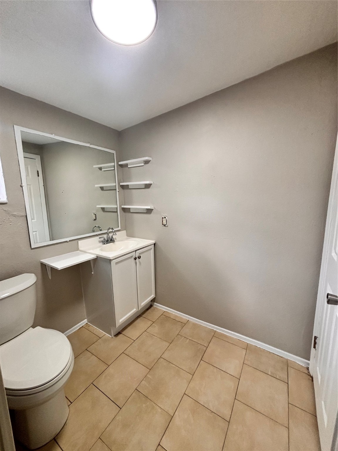 216 Redan Street, Unit 4 Houston, TX 77009 - Photo 6 of 8 a bathroom with a sink toilet and mirror