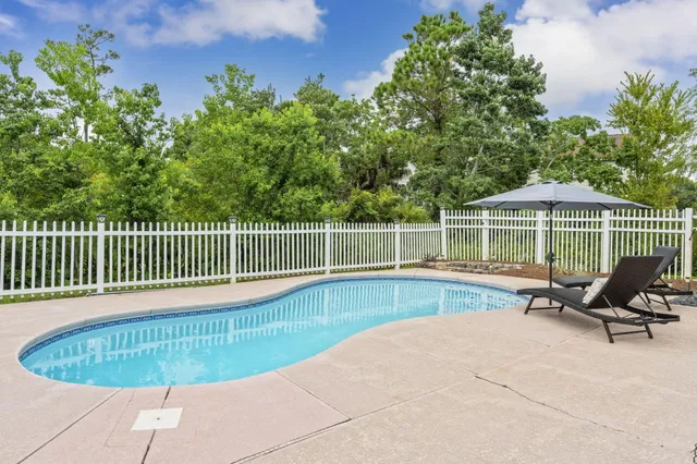 a view of a swimming pool with a lounge chair