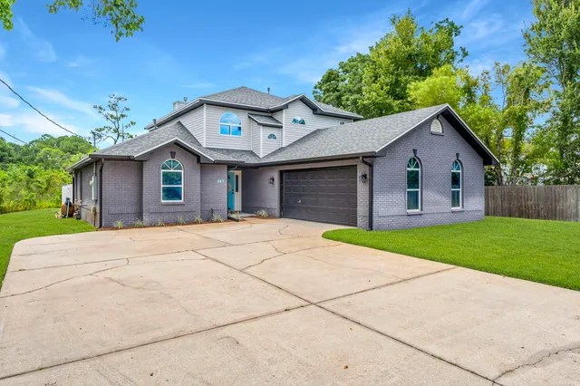 a front view of a house with a yard and garage