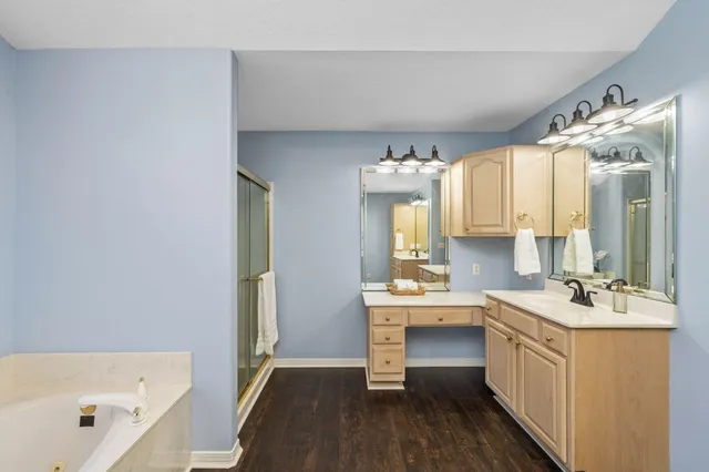 a view of a workspace with furniture and wooden floor