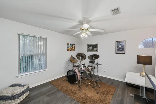 a view of staircase with a large window and wooden floor