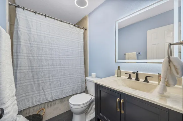 a patio with a table and chairs under an umbrella