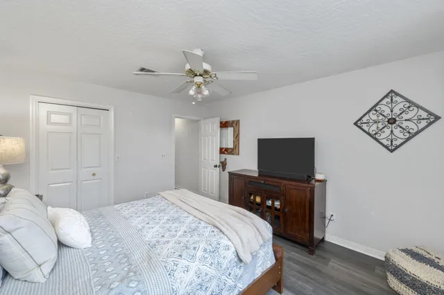 a view of a swimming pool with a patio and a yard