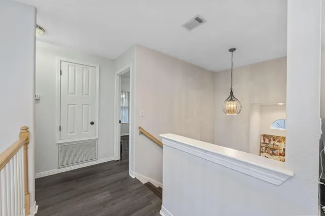 an aerial view of a house with a garden and lake view