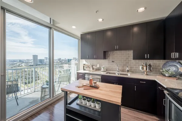 a kitchen with a sink and a stove top oven