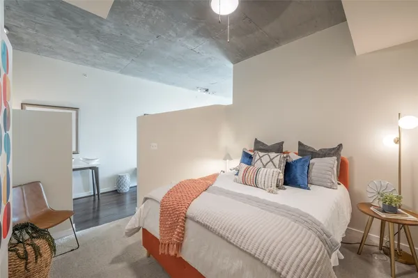 a bedroom with a bed and a chair