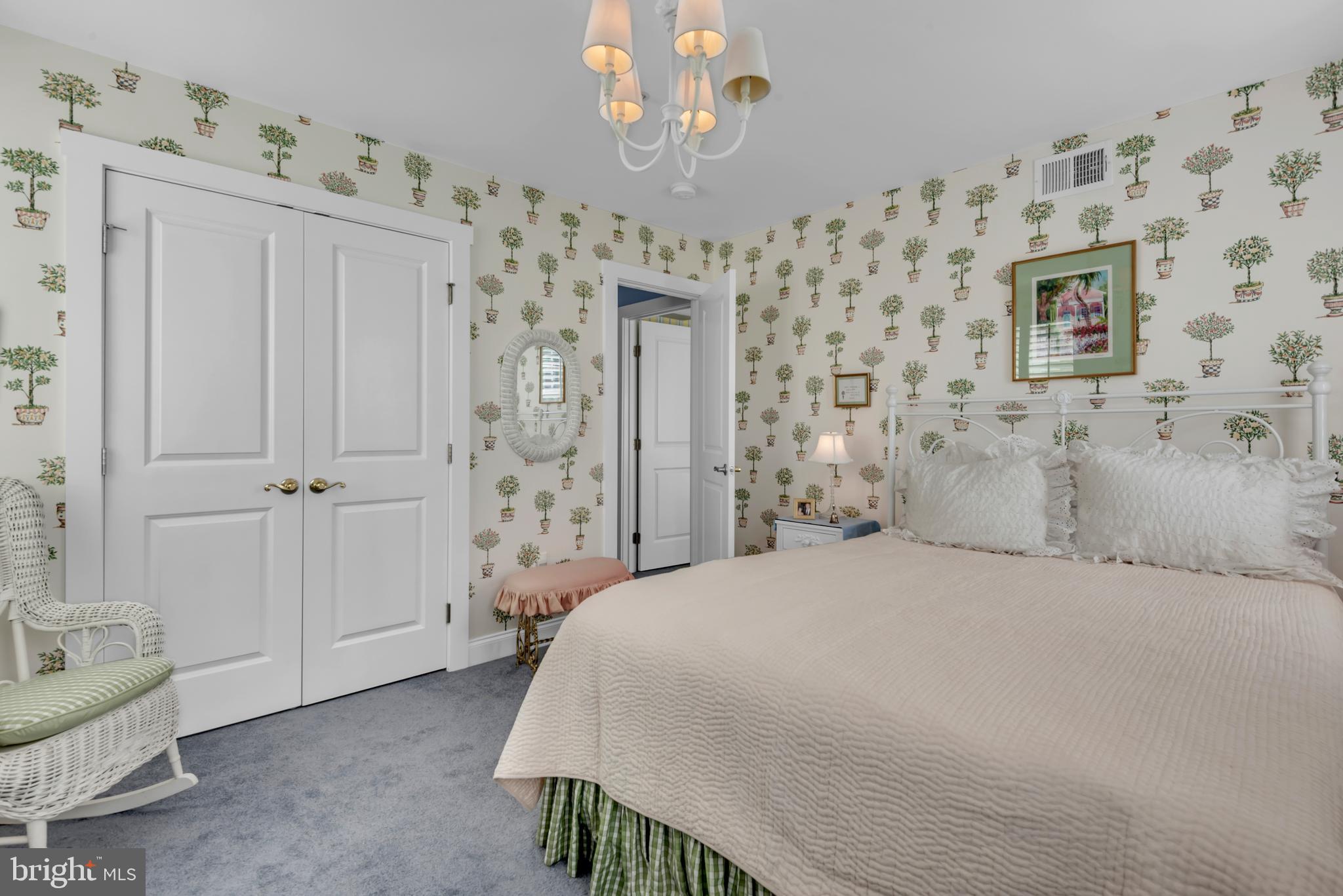 10 Sailors Way Annapolis, MD 21403 - Photo 21 of 36 a spacious bedroom with a bed and a chair