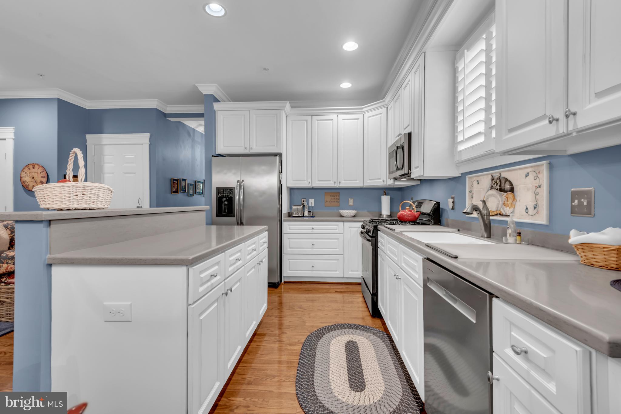 10 Sailors Way Annapolis, MD 21403 - Photo 6 of 36 a kitchen with granite countertop white cabinets and white appliances