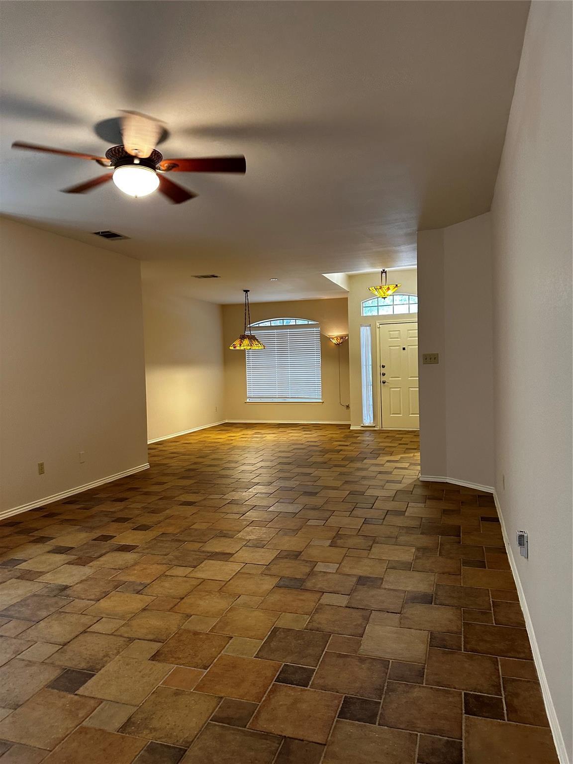 8007 Bounty Trail Austin, TX 78749 - Photo 15 of 32 A spacious living area featuring durable tile flooring and natural light from a window with blinds.