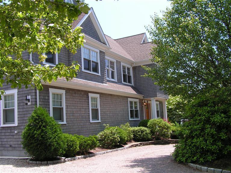 486 Williston Road Sagamore Beach, MA 02562 - Photo 3 of 35 a front view of a house with a yard and potted plants