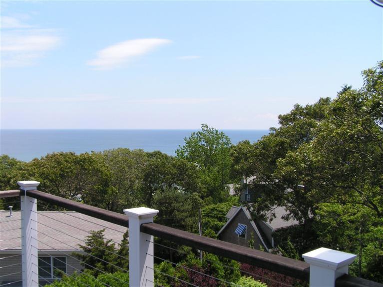 486 Williston Road Sagamore Beach, MA 02562 - Photo 8 of 35 a view of a balcony with wooden fence and floor