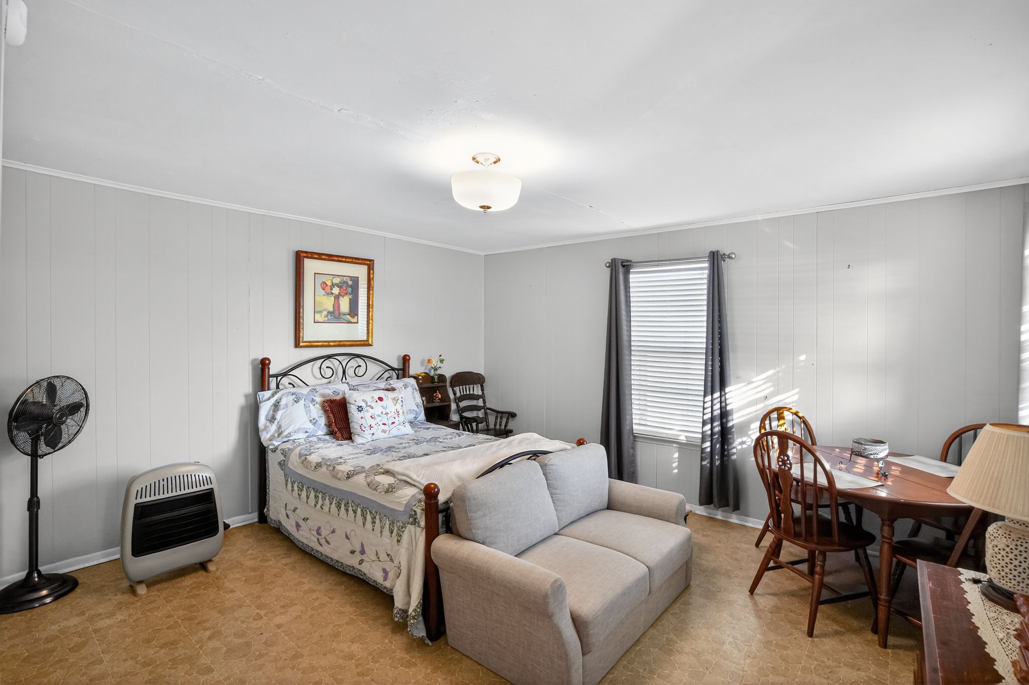 1309 Blackjack Street Lockhart, TX 78644 - Photo 11 of 15 a bedroom with furniture and a chair