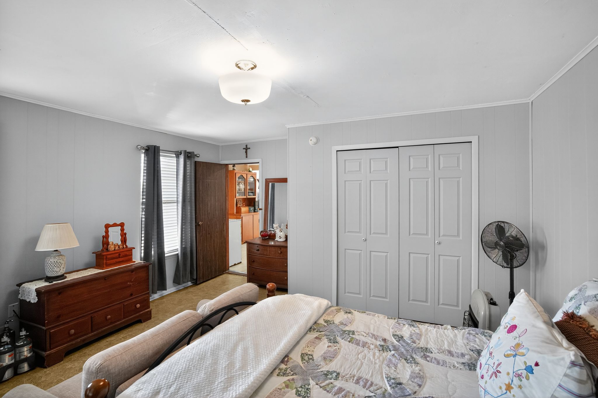 1309 Blackjack Street Lockhart, TX 78644 - Photo 12 of 15 a bedroom with a bed and a chandelier