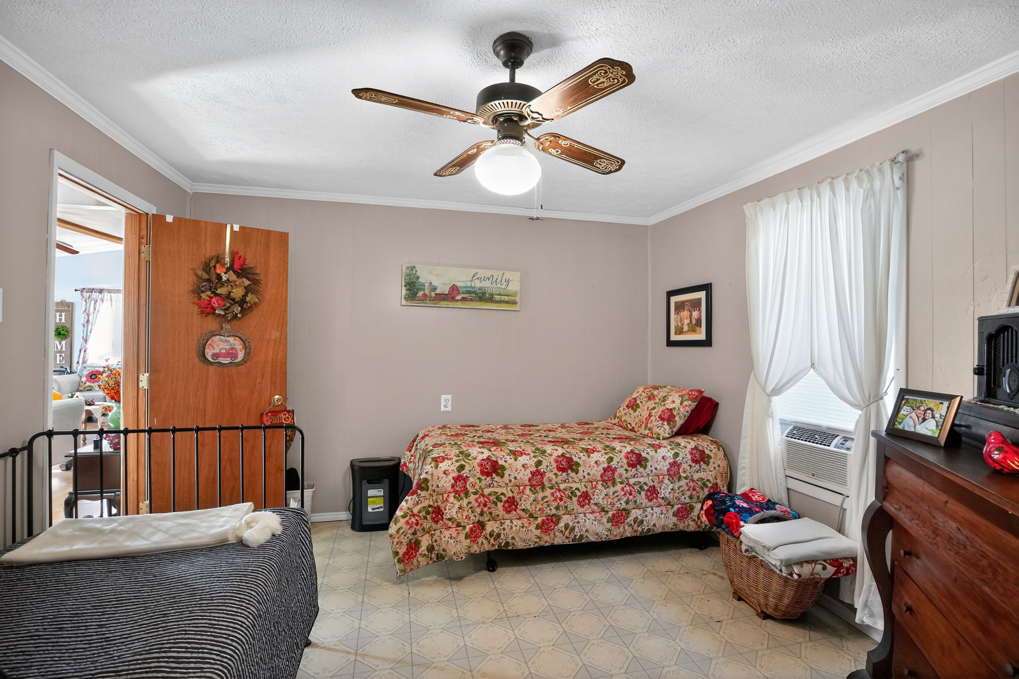 1309 Blackjack Street Lockhart, TX 78644 - Photo 13 of 15 a bedroom with a bed and a chandelier