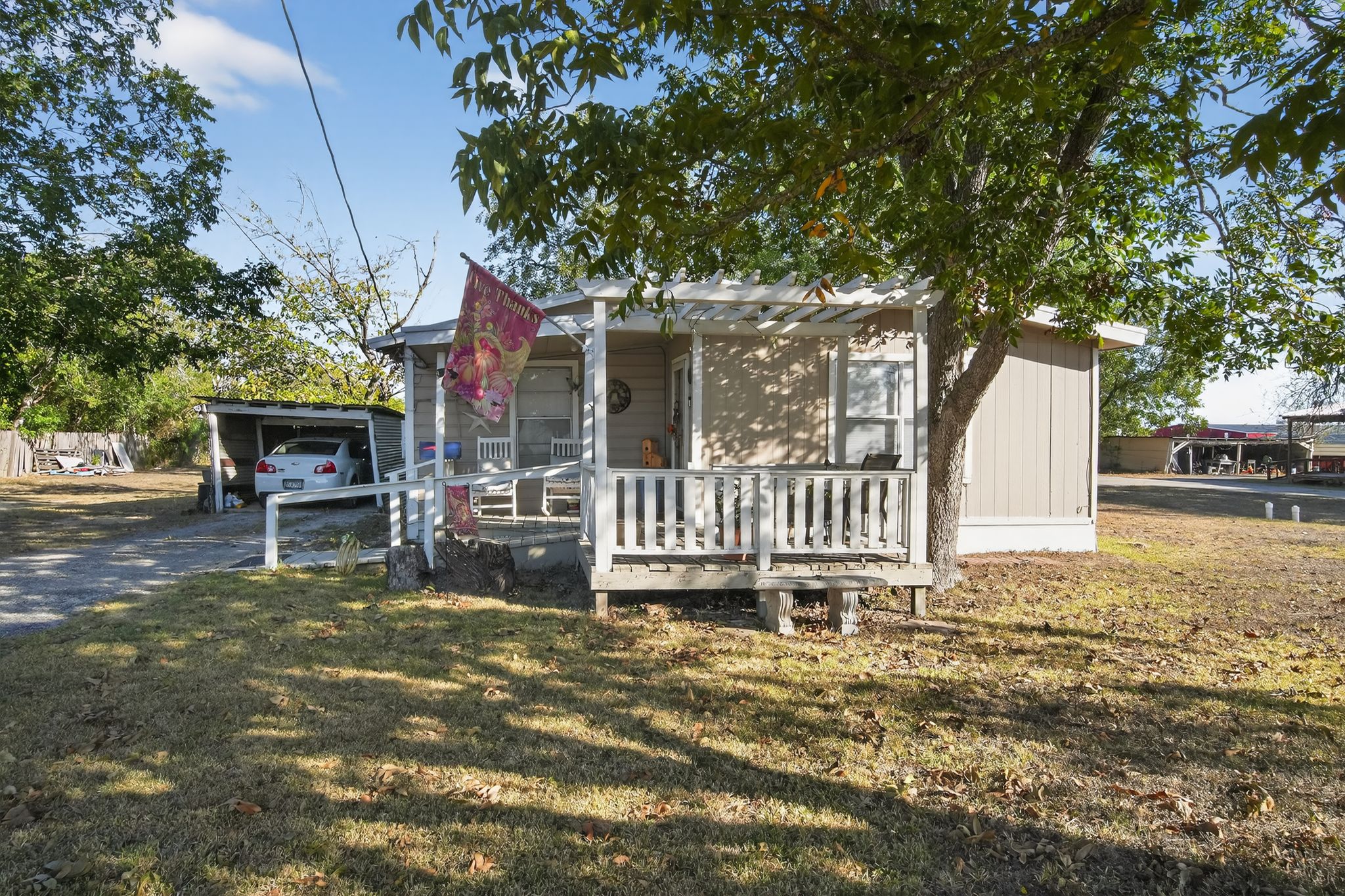 1309 Blackjack Street Lockhart, TX 78644 - Photo 2 of 15 a view of a house with a chairs in patio