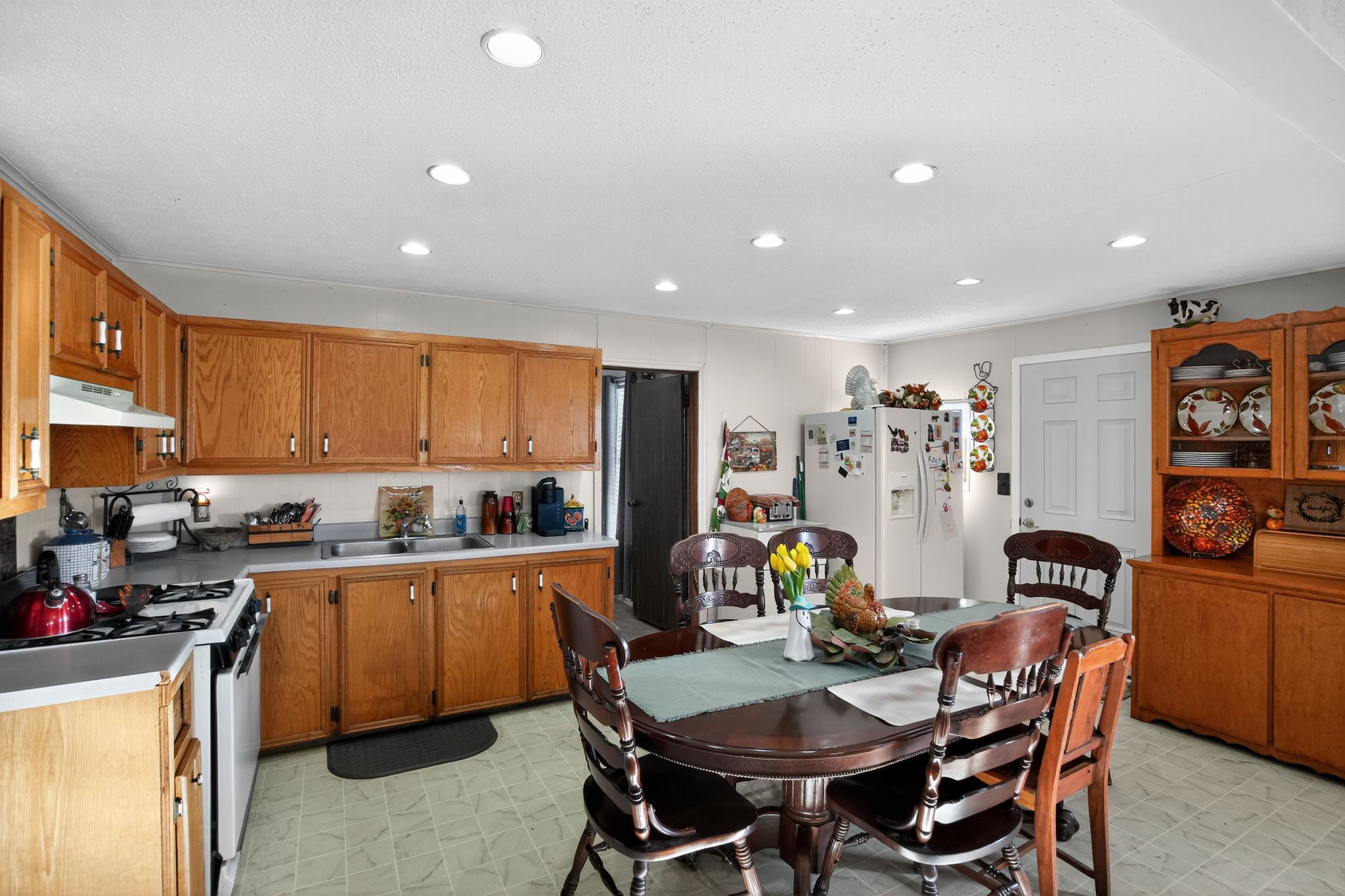 1309 Blackjack Street Lockhart, TX 78644 - Photo 8 of 15 a view of a dining room with furniture and a kitchen
