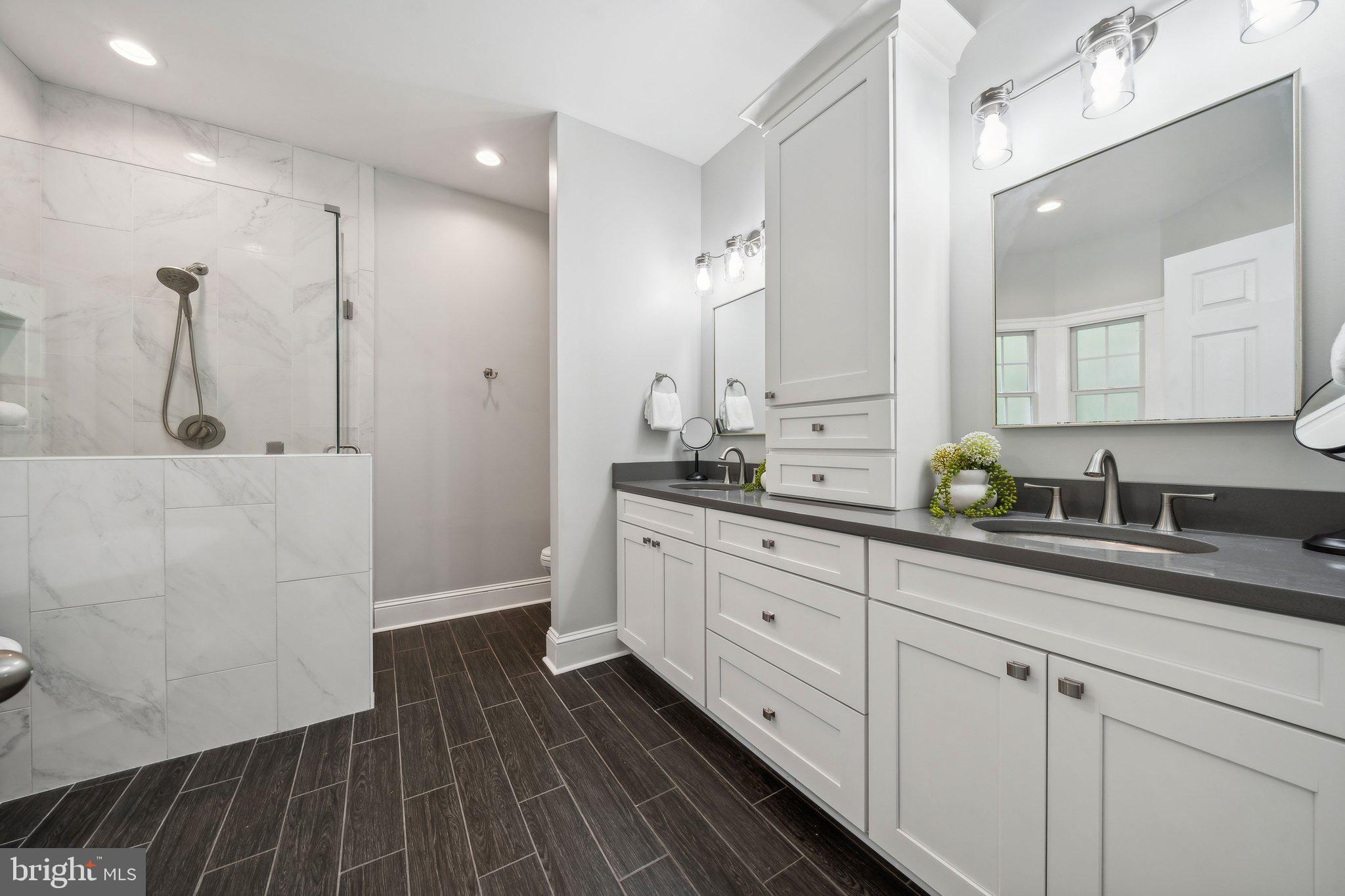 15130 Deep Spring Drive Montpelier, VA 23192 - Photo 32 of 66 a spacious bathroom with a double vanity sink a mirror and shower