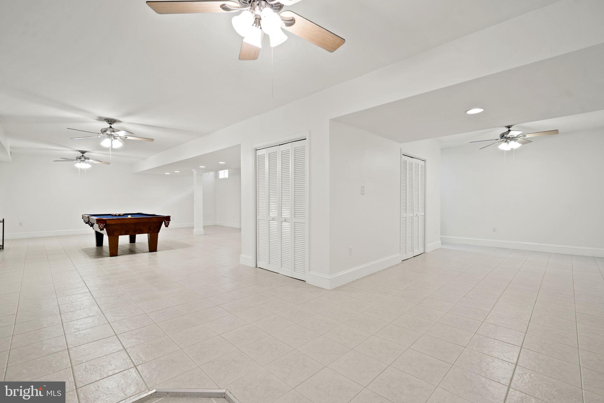 15130 Deep Spring Drive Montpelier, VA 23192 - Photo 47 of 66 a view of an empty room with a chandelier fan and a bookshelf