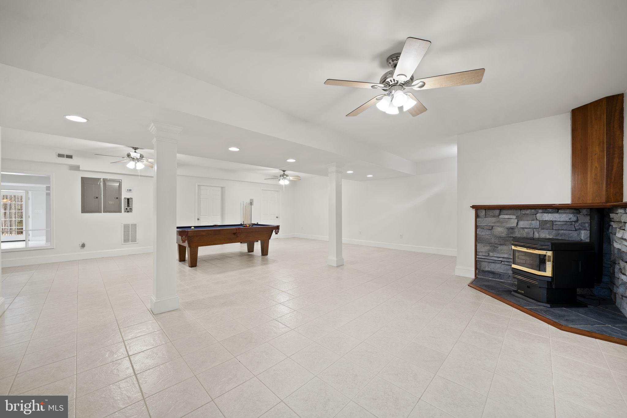 15130 Deep Spring Drive Montpelier, VA 23192 - Photo 55 of 66 a view of a livingroom with a fireplace a ceiling fan and a kitchen view