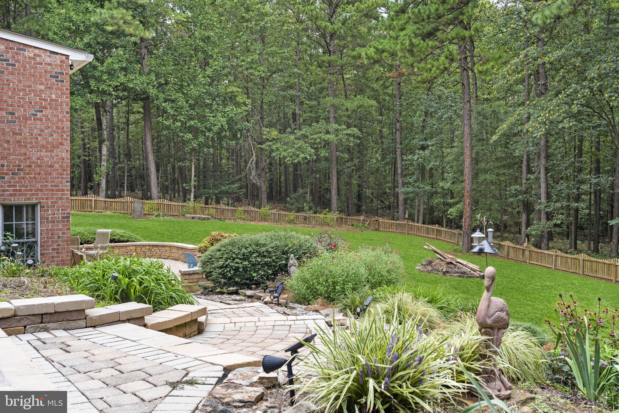 15130 Deep Spring Drive Montpelier, VA 23192 - Photo 57 of 66 a view of a backyard with potted plants and large trees