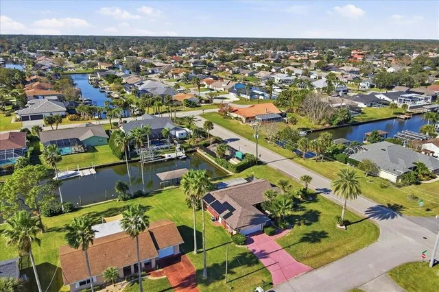 a view of a swimming pool with a deck and a garden