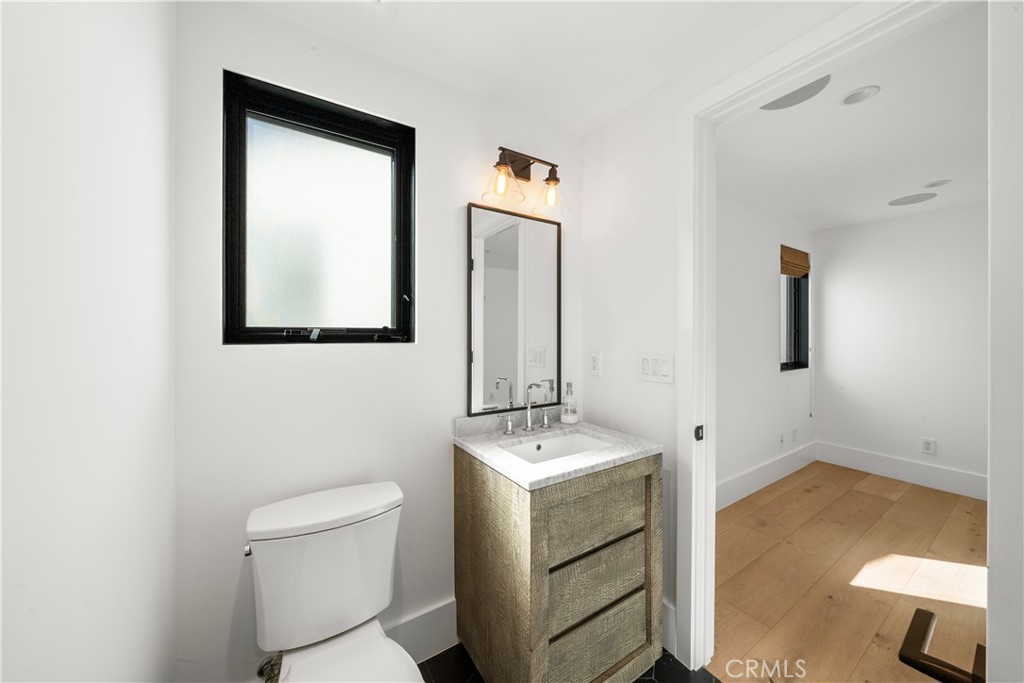 616 Acacia Avenue Corona del Mar, CA 92625 - Photo 12 of 20 a bathroom with a toilet sink and mirror