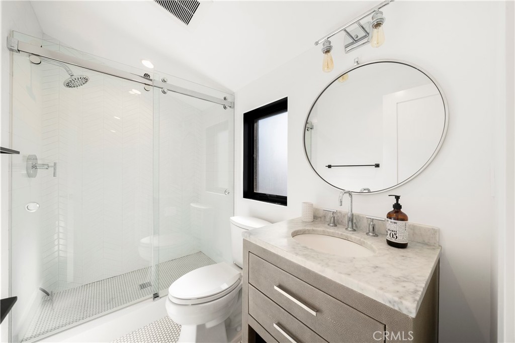 616 Acacia Avenue Corona del Mar, CA 92625 - Photo 15 of 20 a bathroom with a sink a toilet and a mirror