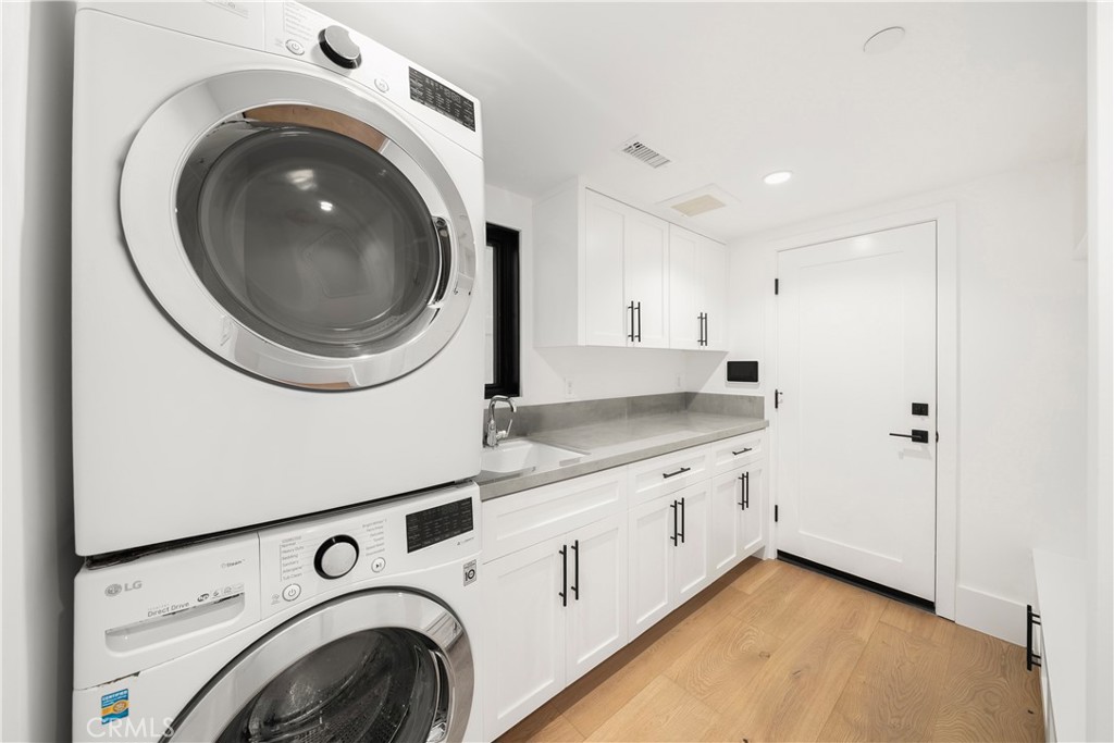 616 Acacia Avenue Corona del Mar, CA 92625 - Photo 20 of 20 a utility room with sink dryer and washer