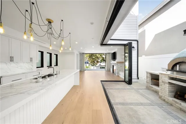 a large white kitchen with a large window