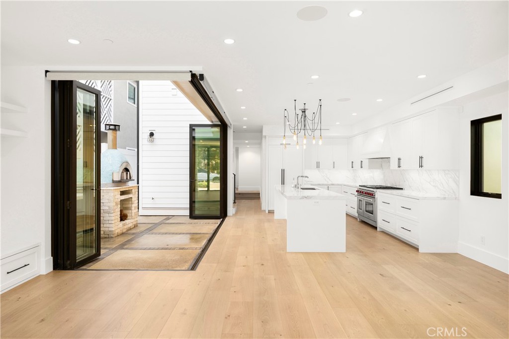 616 Acacia Avenue Corona del Mar, CA 92625 - Photo 4 of 20 a large white kitchen with a stove a sink and a refrigerator