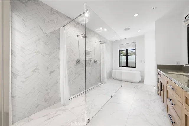 a spacious bathroom with a granite countertop sink mirror and