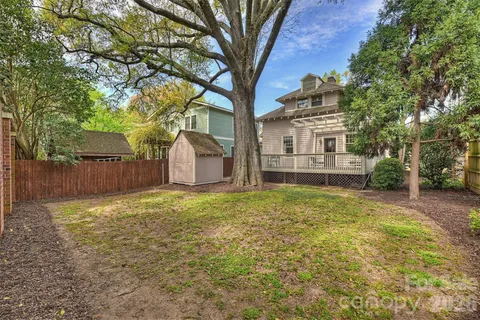 a backyard of a house with oven and tree