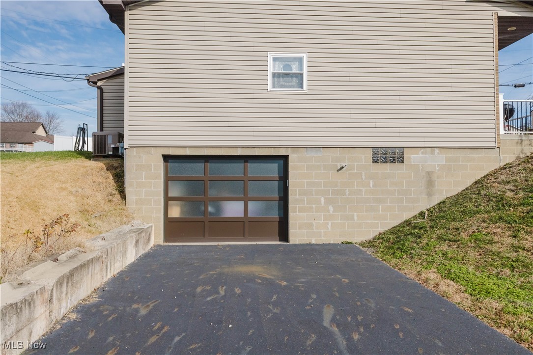 857 Archer Hill Road Colliers, WV 26035 - Photo 5 of 37 Back of property with asphalt driveway and a garage