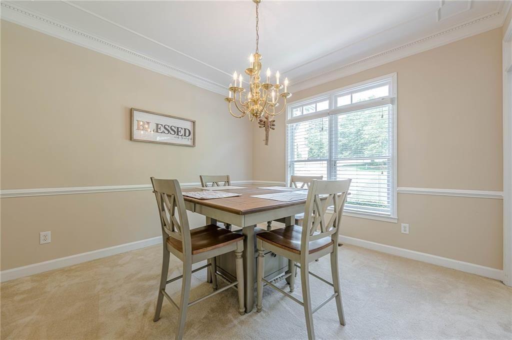 1765 Pinetree Pass Lane Southwest Lilburn, GA 30047 - Photo 13 of 44 a view of a dining room with furniture and a chandelier